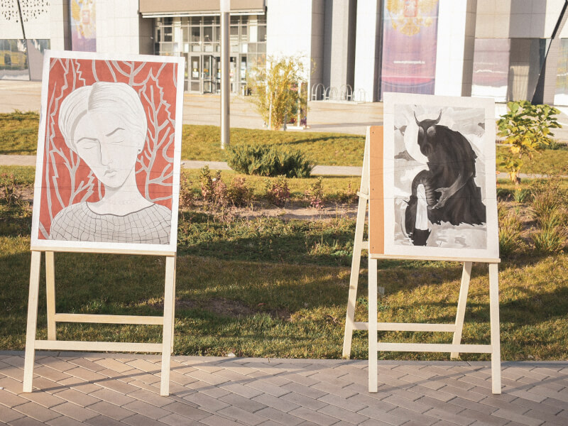 Two paintings on easels outside